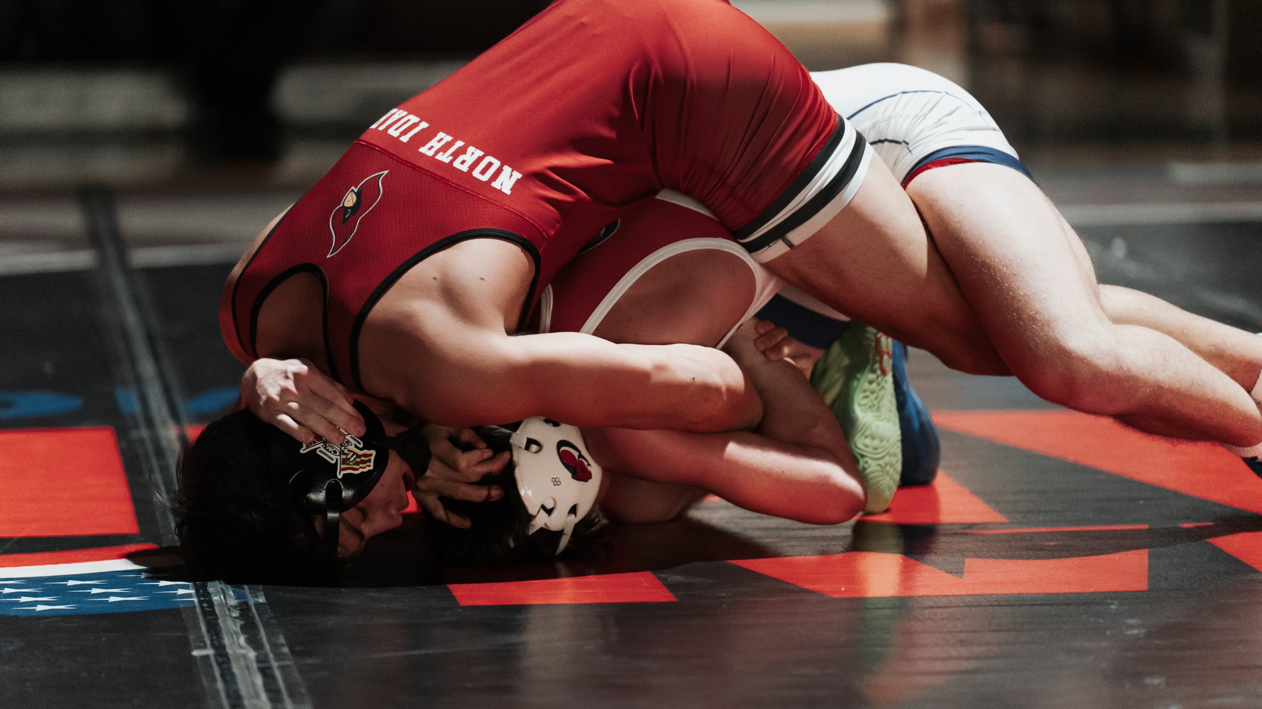 Wrestling Team member competing with opponent on the floor