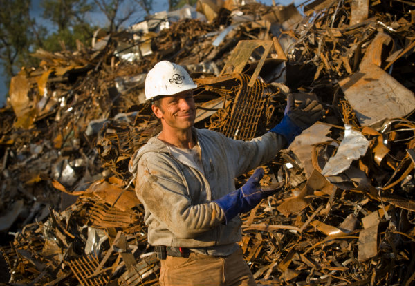 Person in hard hat in front of dump pile