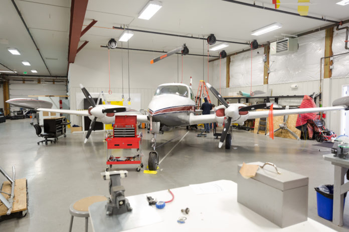 Small airplane in a garage being worked on