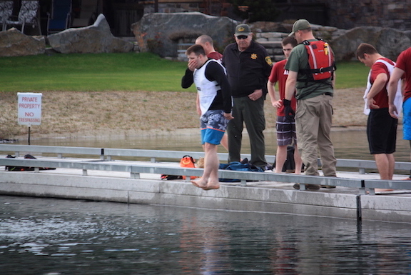 Law enforcement student jumps into the water for safety training