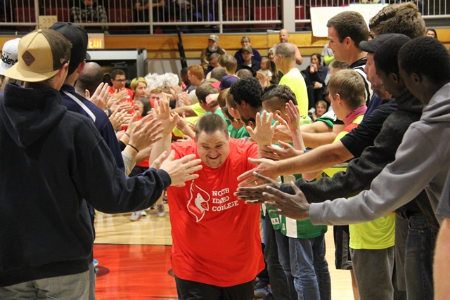 Participants in a past NIC Special Needs Basketball Extravaganza enter the court
