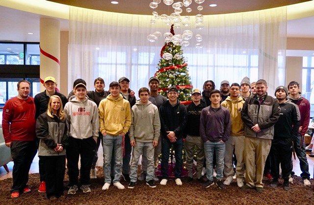 Wrestling Team standing in front of a Christmas tree