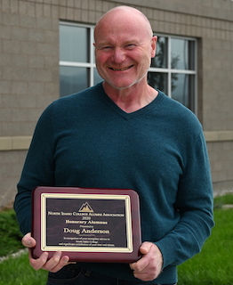 Doug Anderson holding a plaque