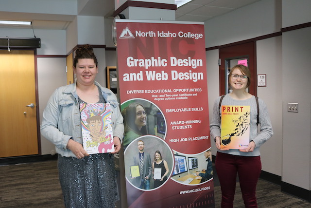 NIC graphic design student winners holding their designs
